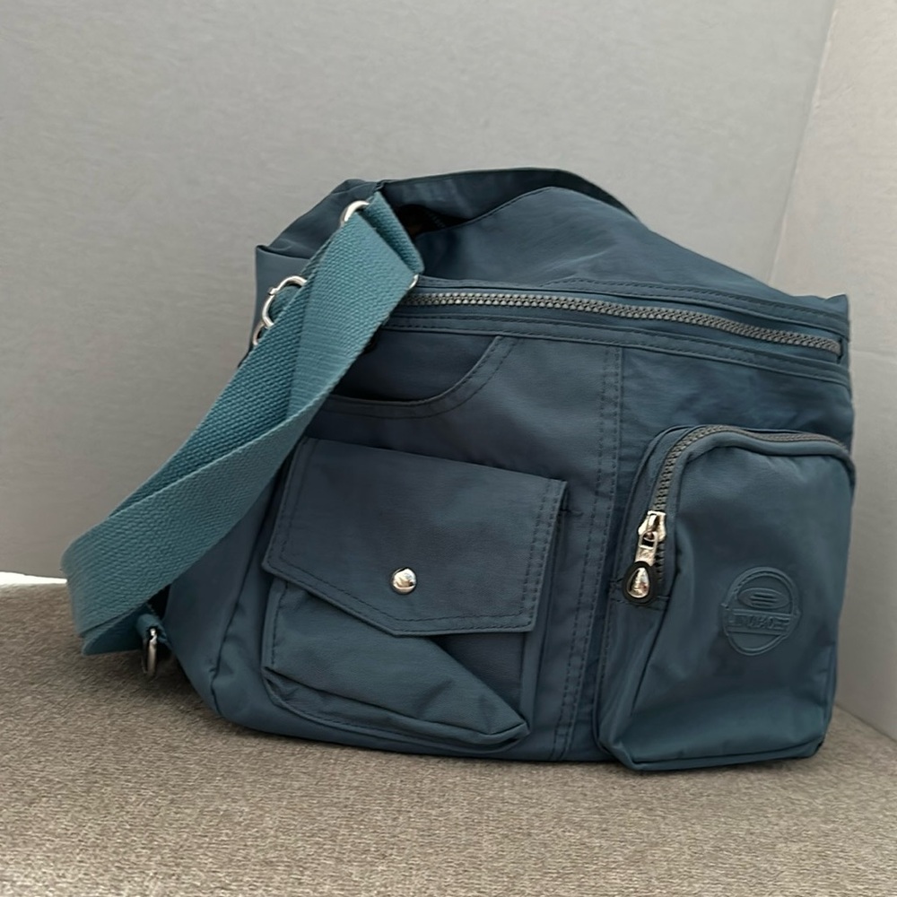 Slate blue handbag. Unknown brand. Gortex-like material. Converts to backpack.